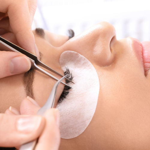 woman having eyelash extension treatment