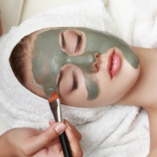 woman having chemical peel treatment and mixture is brushed on face