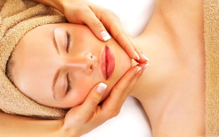 woman having facial treament massage on spa