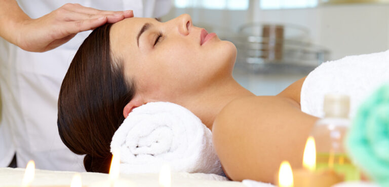 woman having facing massage in spa
